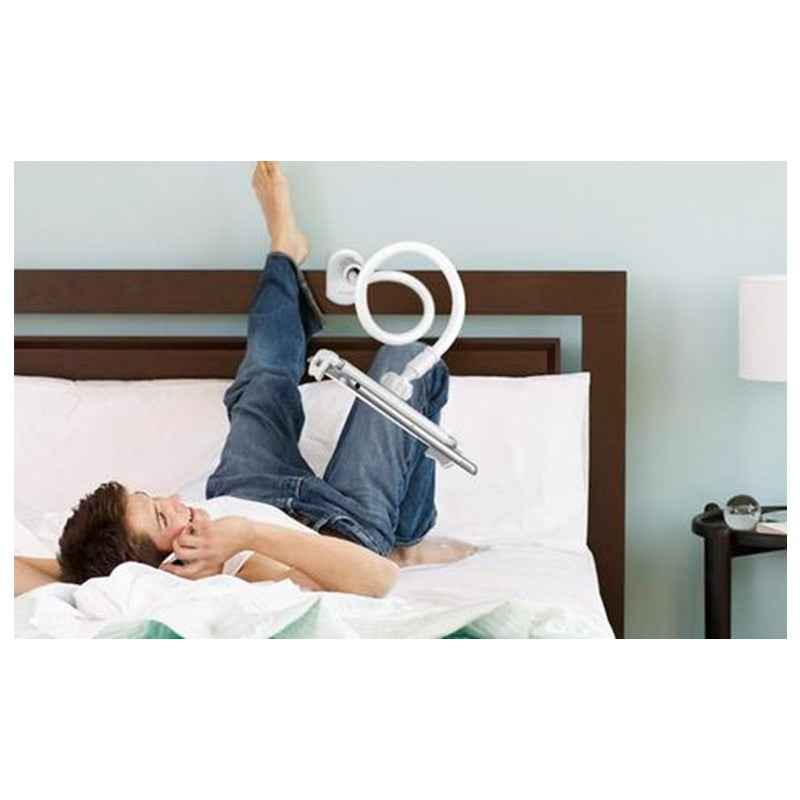 White 360-degree spiral stand holding a smartphone above a bedside bed