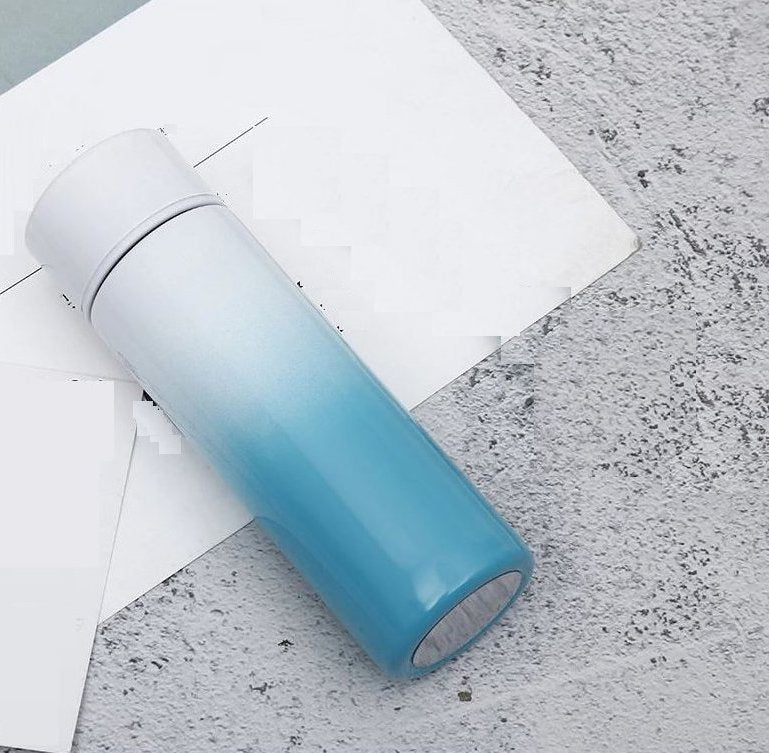 Vacuum insulated stainless steel bottle cup, light blue gradient with black rim and lid