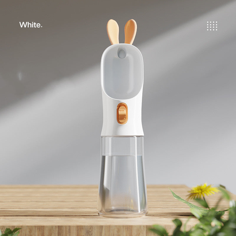 Pet water travel bottle with bunny-ear lid in white; clear water chamber