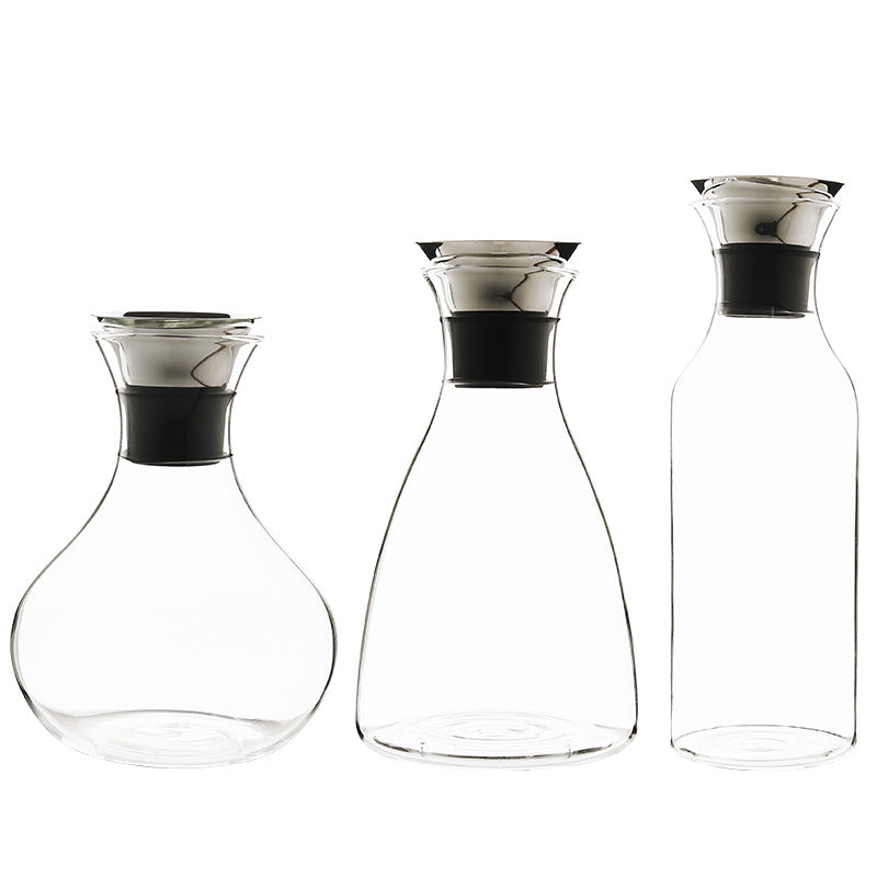 Set of clear glass cold water bottles with black top collars, three sizes shown