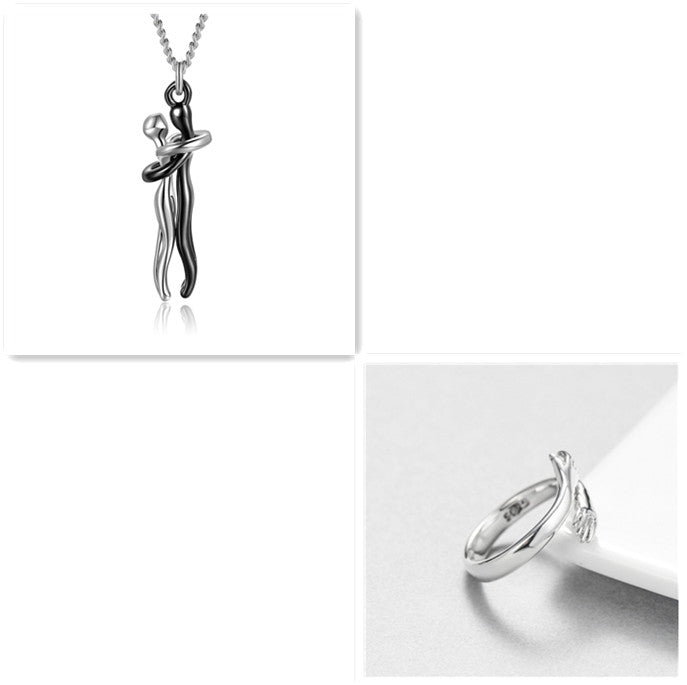 Black-and-silver hug-pendant necklace with silver chain and silver-tone ring, polished metal