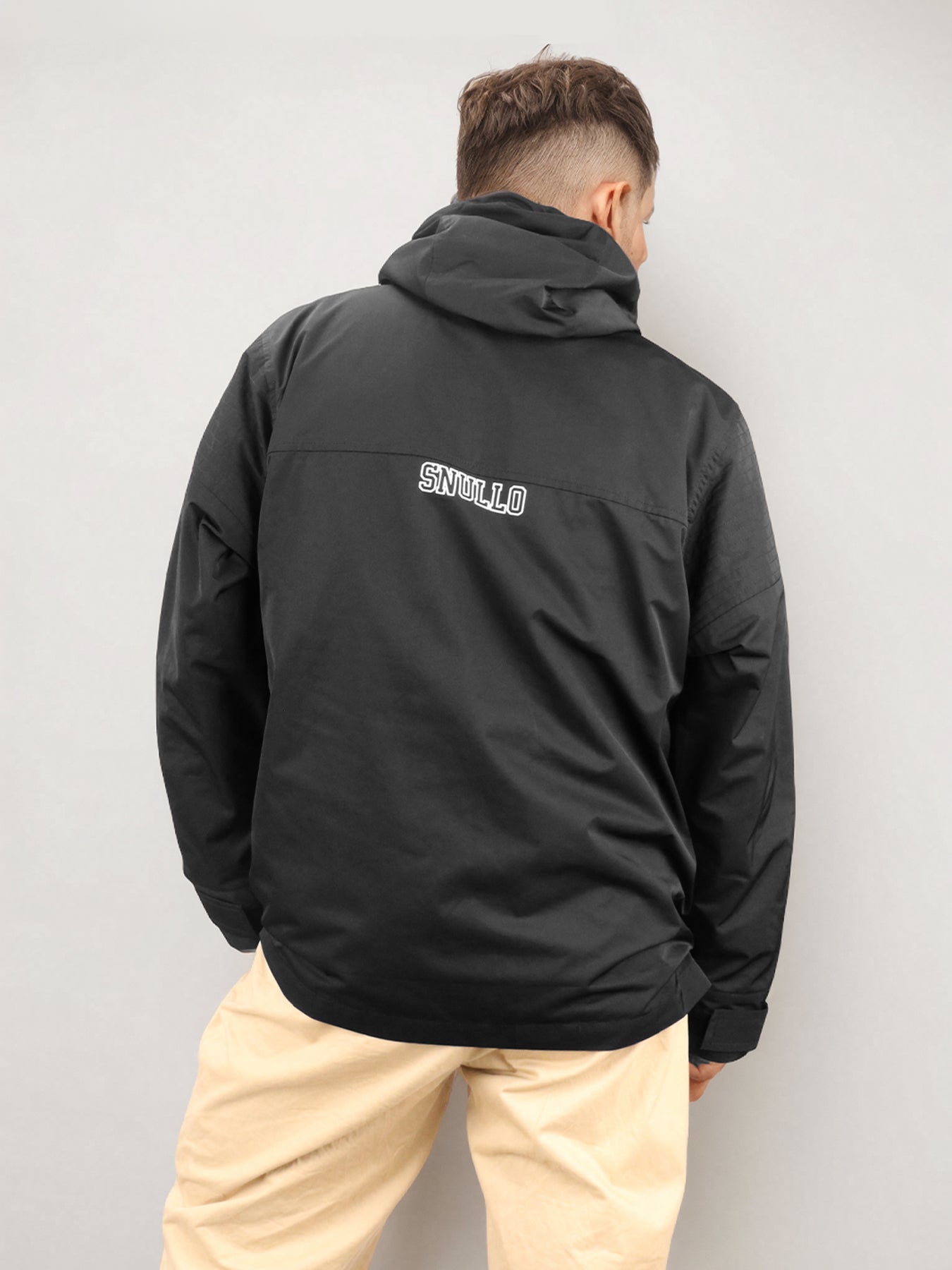 Black hooded jacket back view with small logo patch and center snap placket