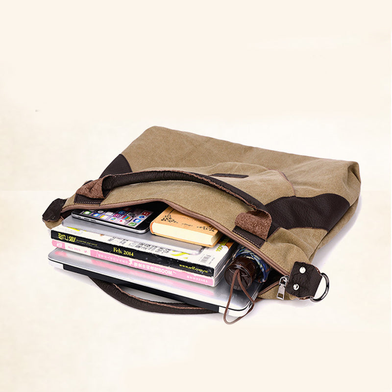 Khaki canvas shoulder bag with zipper top opening and front pocket, holding phone and cards