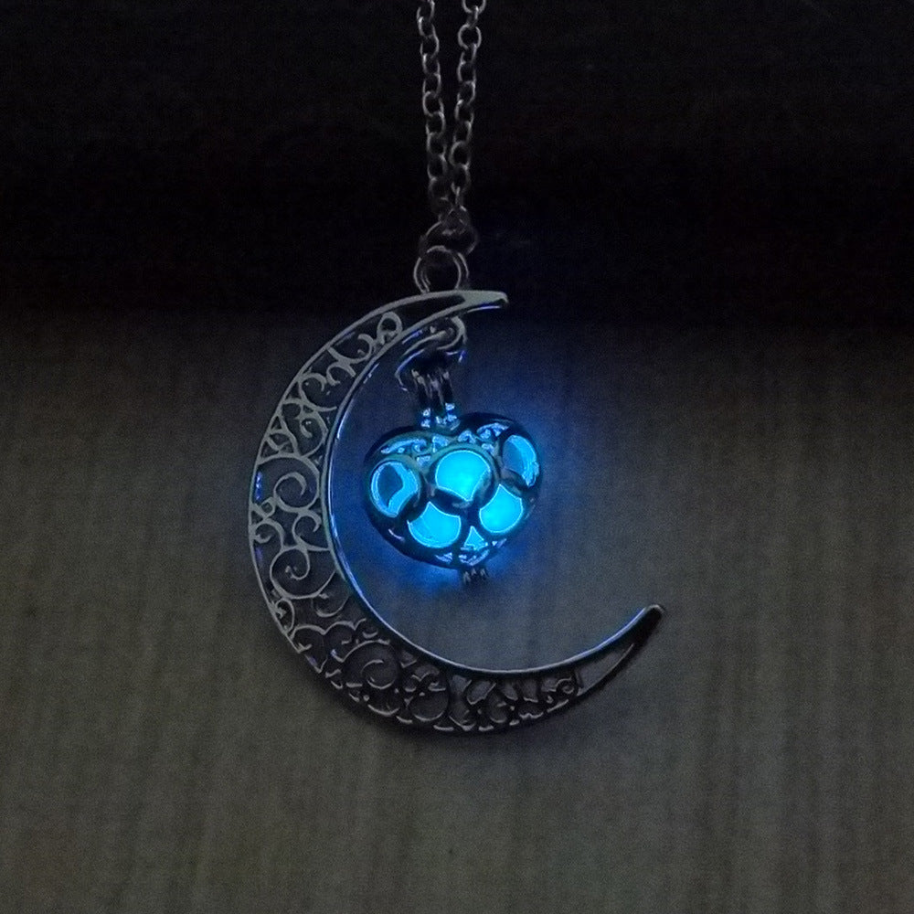 Crescent moon pendant necklace with blue glowing cat paw on a silver chain