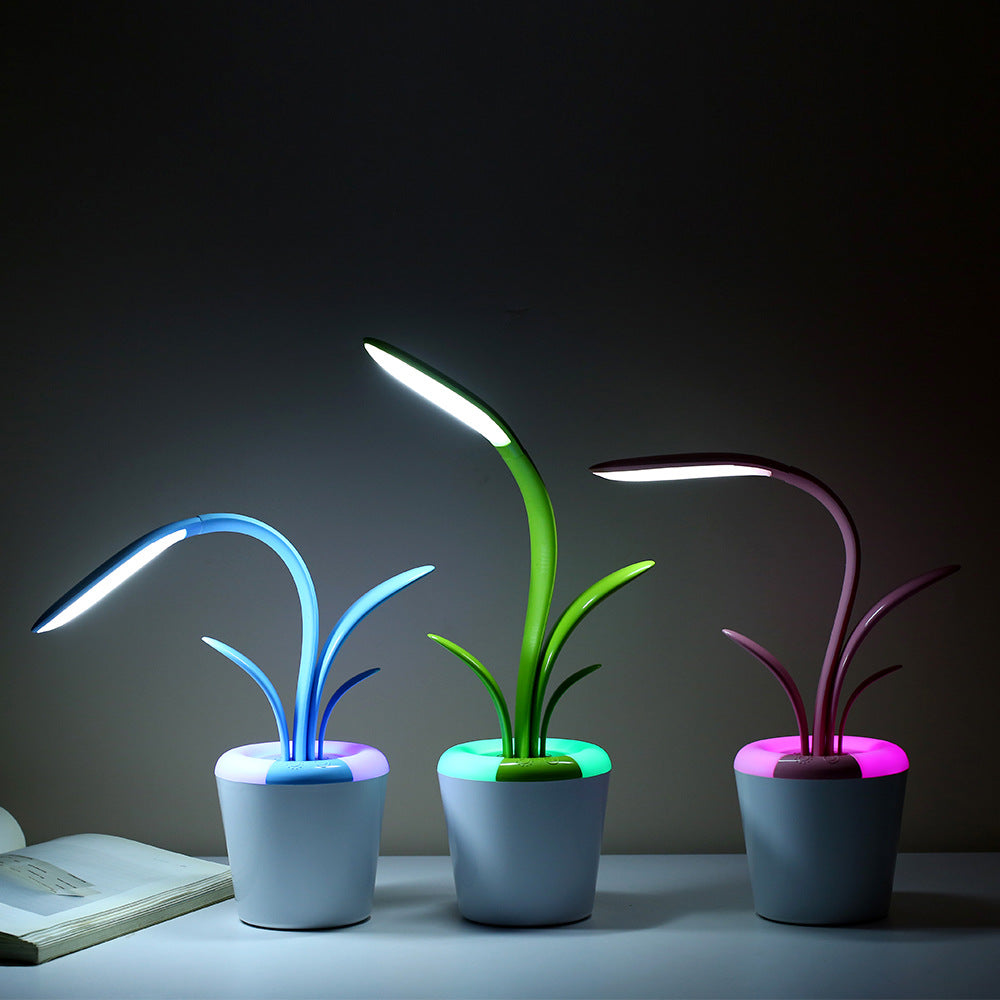 LED table lamp with three neon glowing stems (blue, green, purple) in a white pot