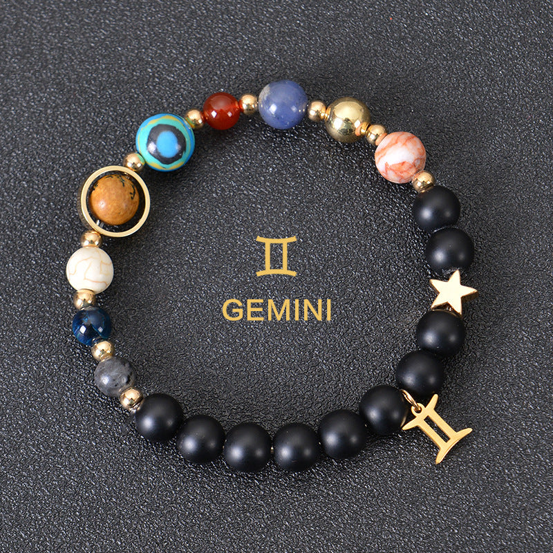 Gemini zodiac beaded bracelet with black matte beads, colorful stone beads, and gold zodiac charm