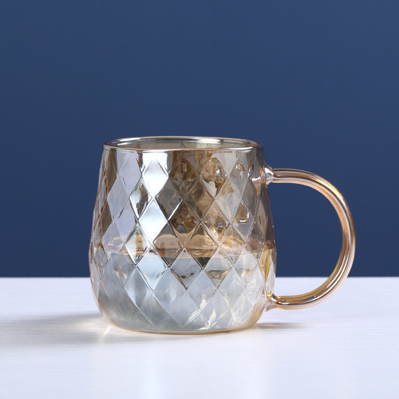 Glass cold water bottle with diamond relief pattern, gold-tone lid and side handle