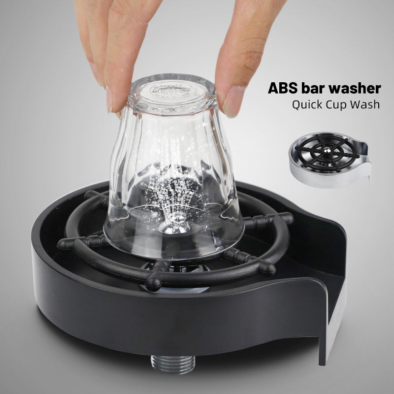 Cup washer with black base holding a clear glass pitcher for quick cleaning