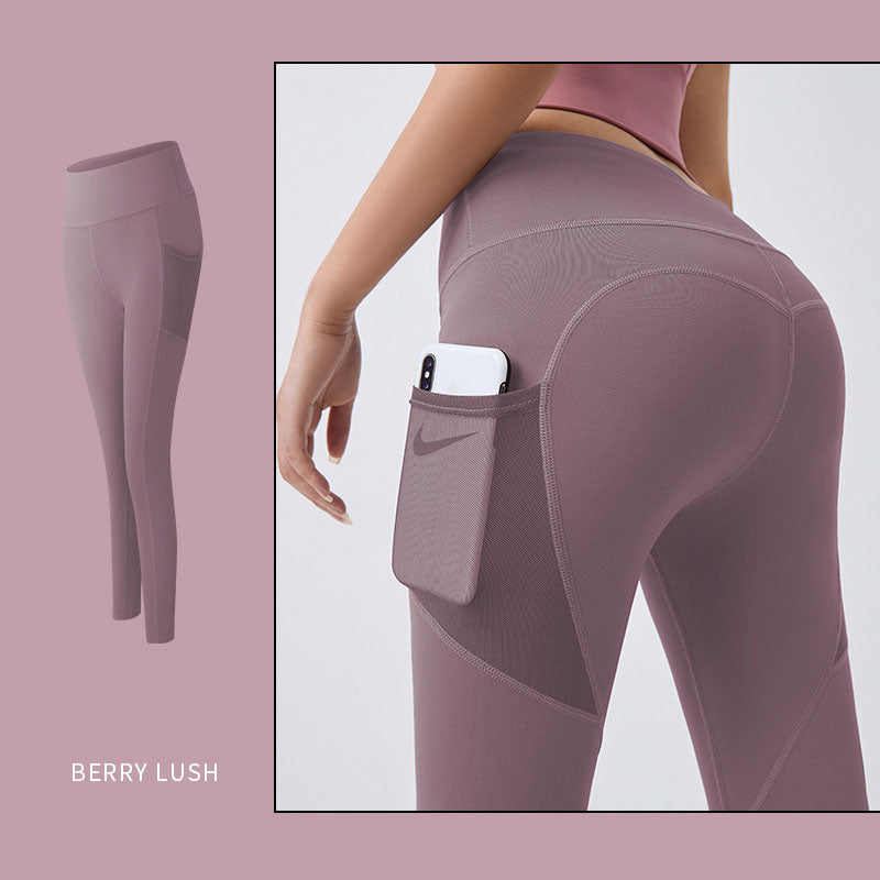 Women’s yoga leggings with phone pocket, berry purple, high-rise back view.