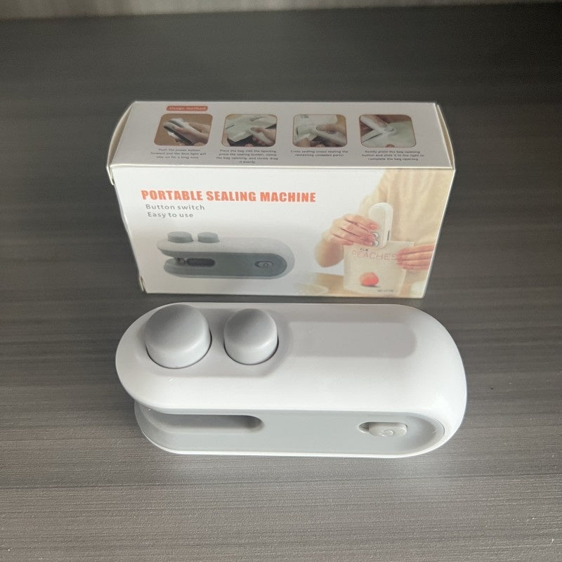 White portable sealing machine on display with included product box