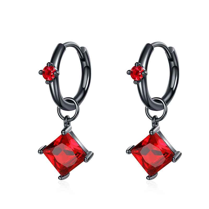 Pair of black gold hoop earrings with red crystal drop charms