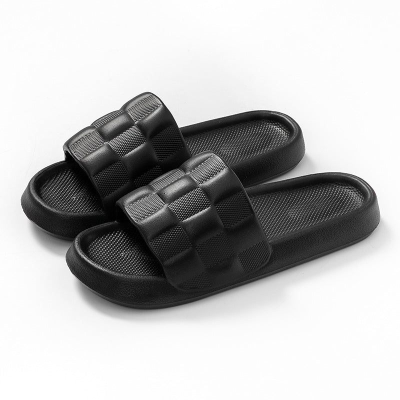 Women's EVA slide sandals in black with checkered cross straps and textured footbed