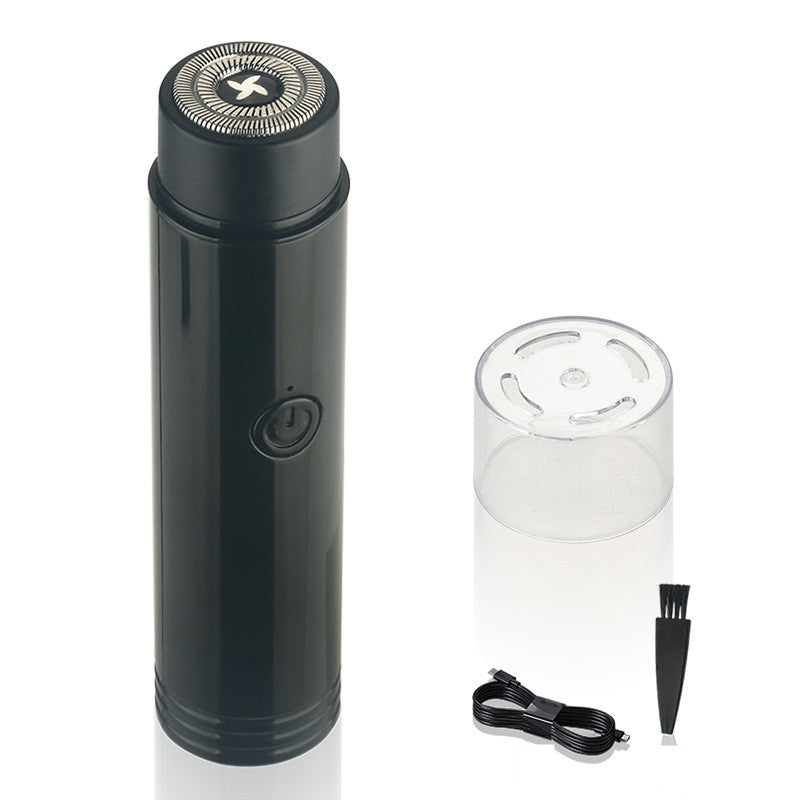 Black portable electric mini shaver with spare head and charging plug.