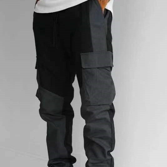 Black cargo trousers with large stitched pockets, loose fit, cuffed ankles