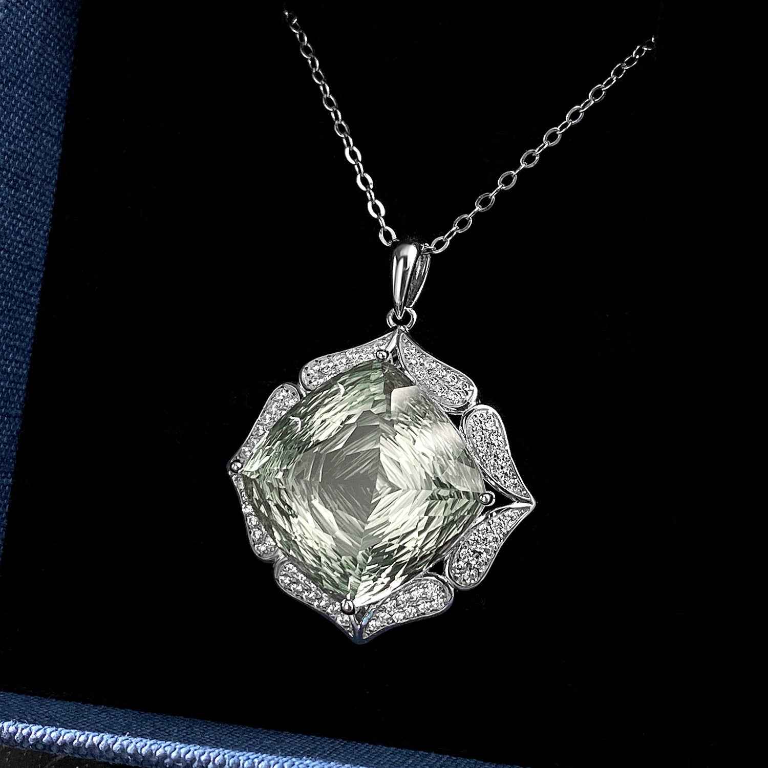 Green crystal pendant on silver chain necklace with faceted center stone and halo