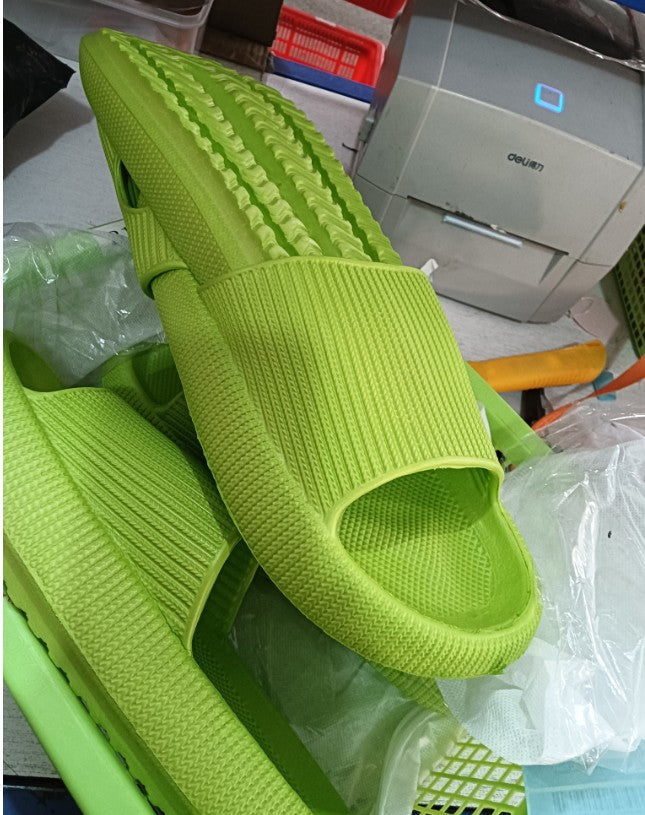 Bright green knit slide slippers with open toe and thick cushioned sole.