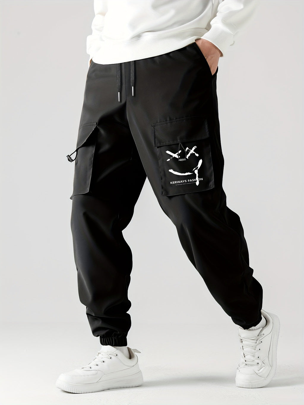 Black straight ankle cargo jogger pants with utility pocket flap and tied accents