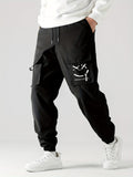 Black straight ankle cargo jogger pants with utility pocket flap and tied accents
