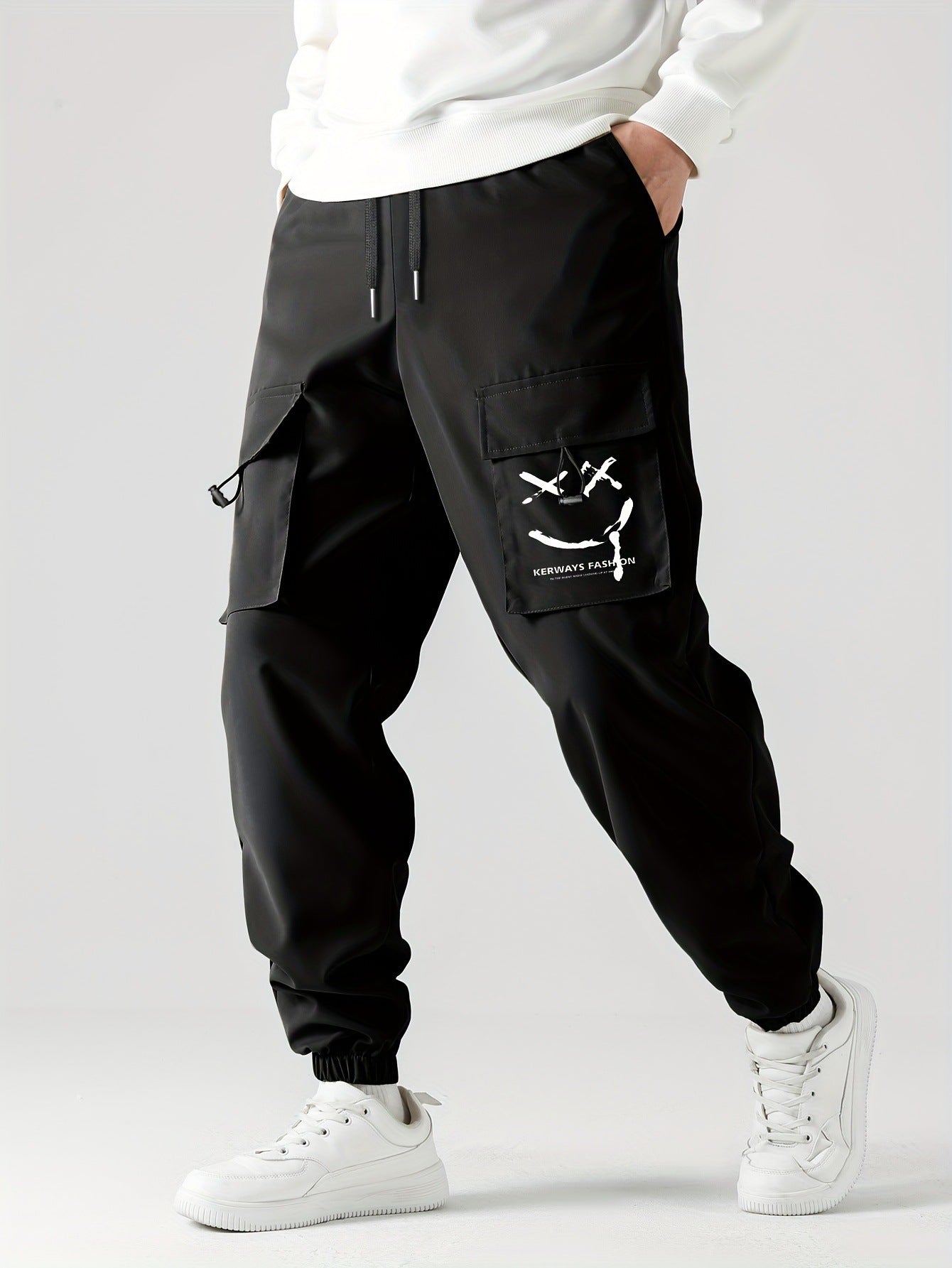 Black straight ankle cargo jogger pants with utility pocket flap and tied accents