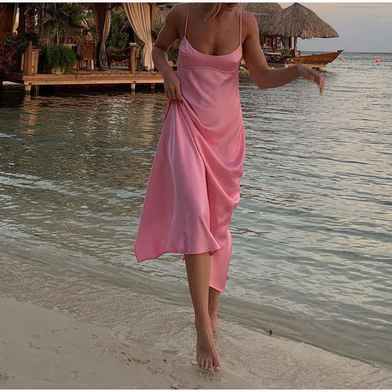 Pink satin midi slip dress with thin straps and flowing skirt