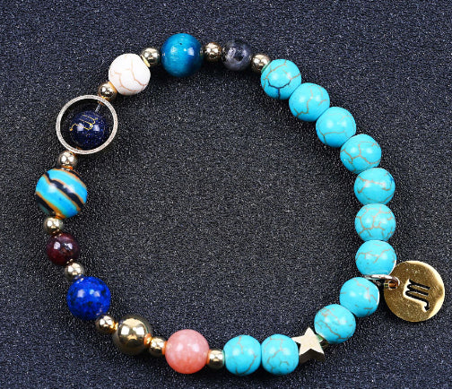 Turquoise beaded bracelet with mixed beads and zodiac charm disks and a small star charm