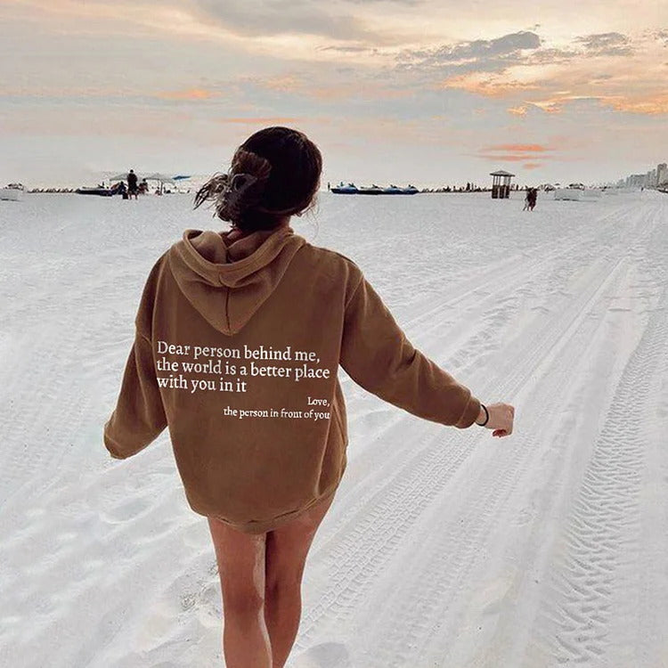 Tan plush hoodie with hood, drawstrings, kangaroo pocket, and printed back message