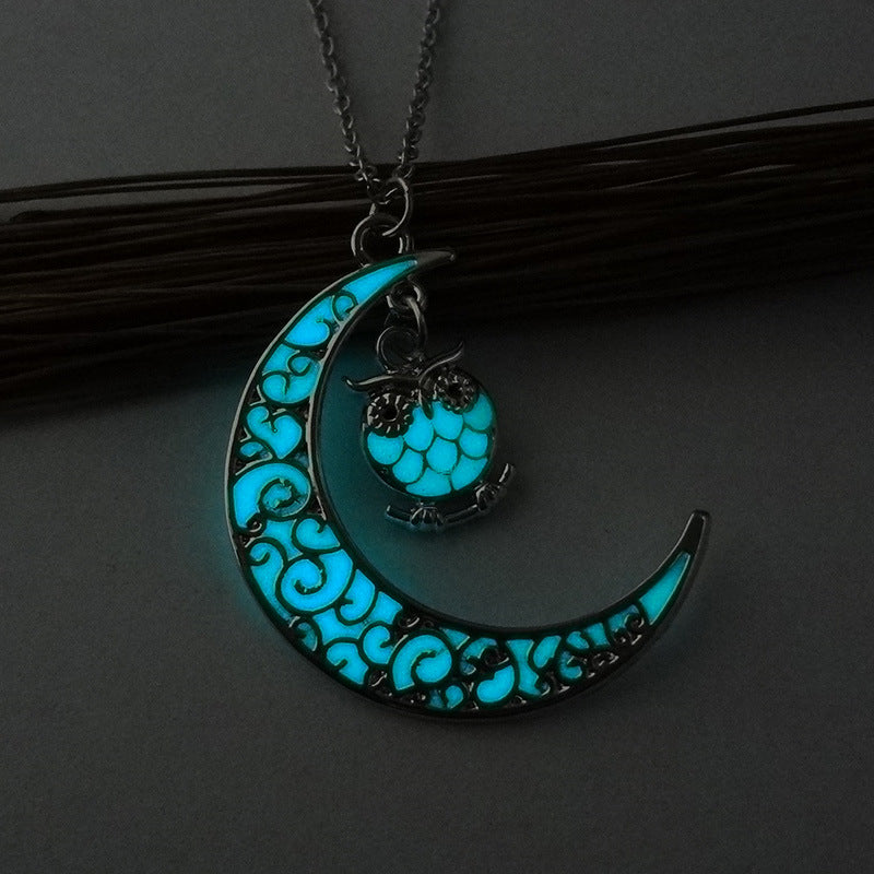 Crescent moon pendant necklace with turquoise glowing owl on a silver chain