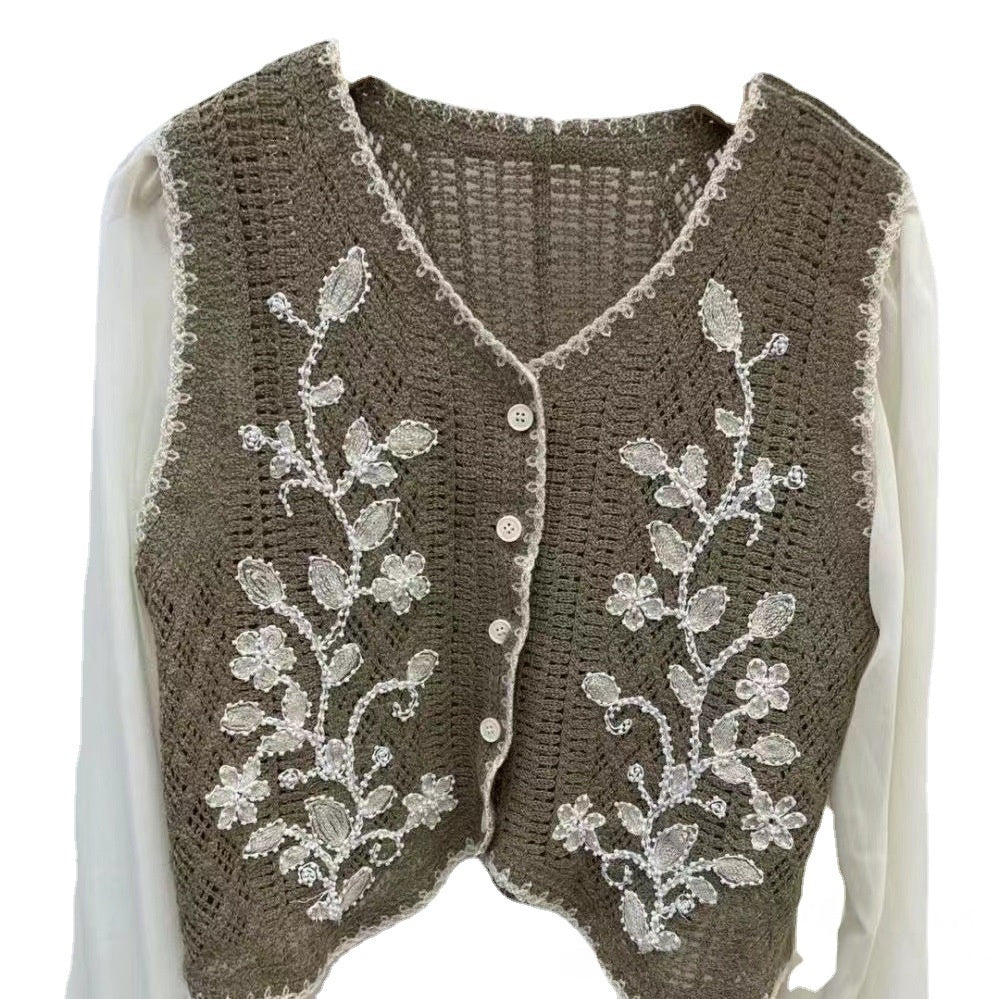Taupe V-neck embroidered sleeveless top with floral vine motifs and button front