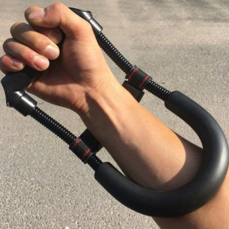 Dark blue forearm grip trainer with spring coils and padded U handles