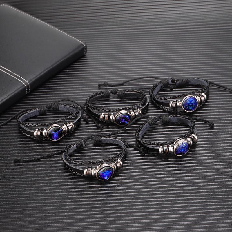 Black braided zodiac bracelets with glowing blue round charms and silver ring details