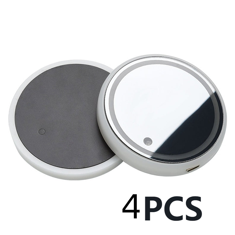 Four round LED light-up coasters with dark gray bases and clear top faces