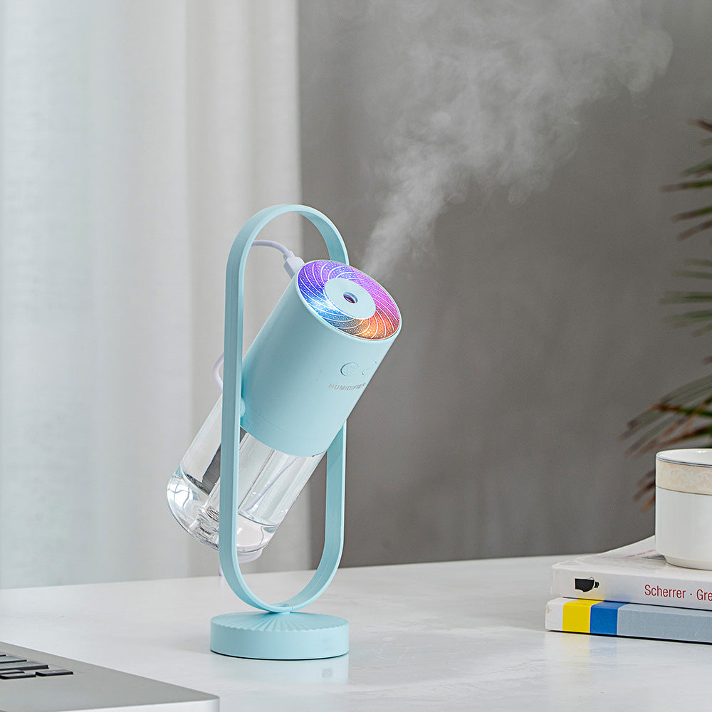 Light blue USB air humidifier with mist outlet and circular light top on stand