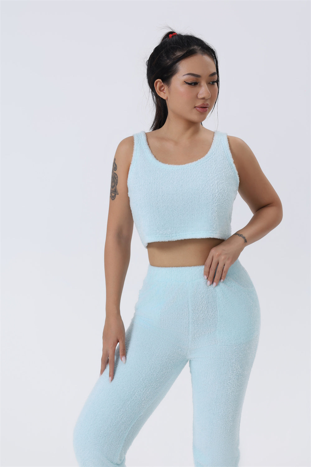 Women’s 3-piece pajama set in light blue: sleeveless crop top and matching pants.