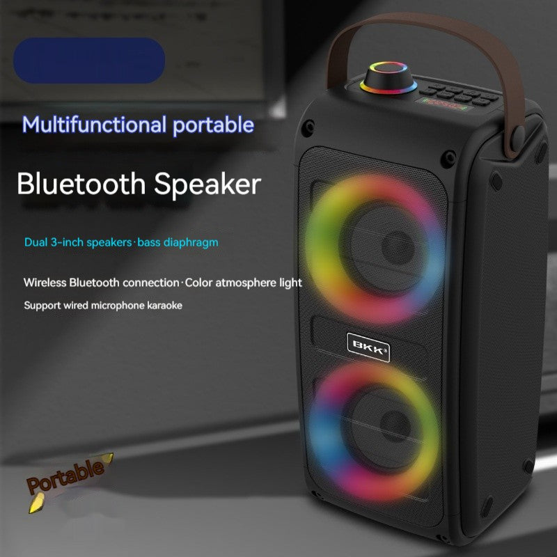 Black portable Bluetooth speaker, front corner view, dual drivers with color light glow.