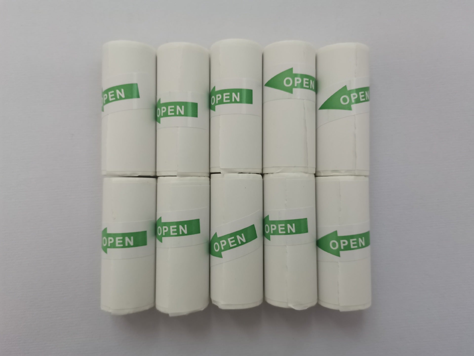 Pack of white paper rolls for mini label printer with green OPEN seals