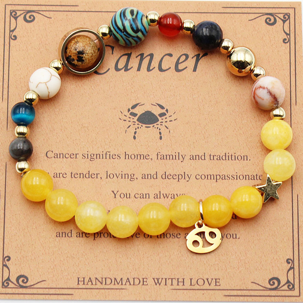 Cancer zodiac beaded bracelet with yellow beads, multicolor beads, and gold crab charm