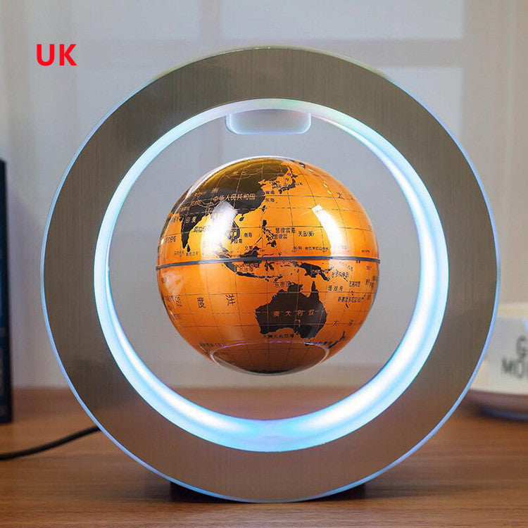 Floating LED world globe with white lit ring and orange illuminated globe map on dark base
