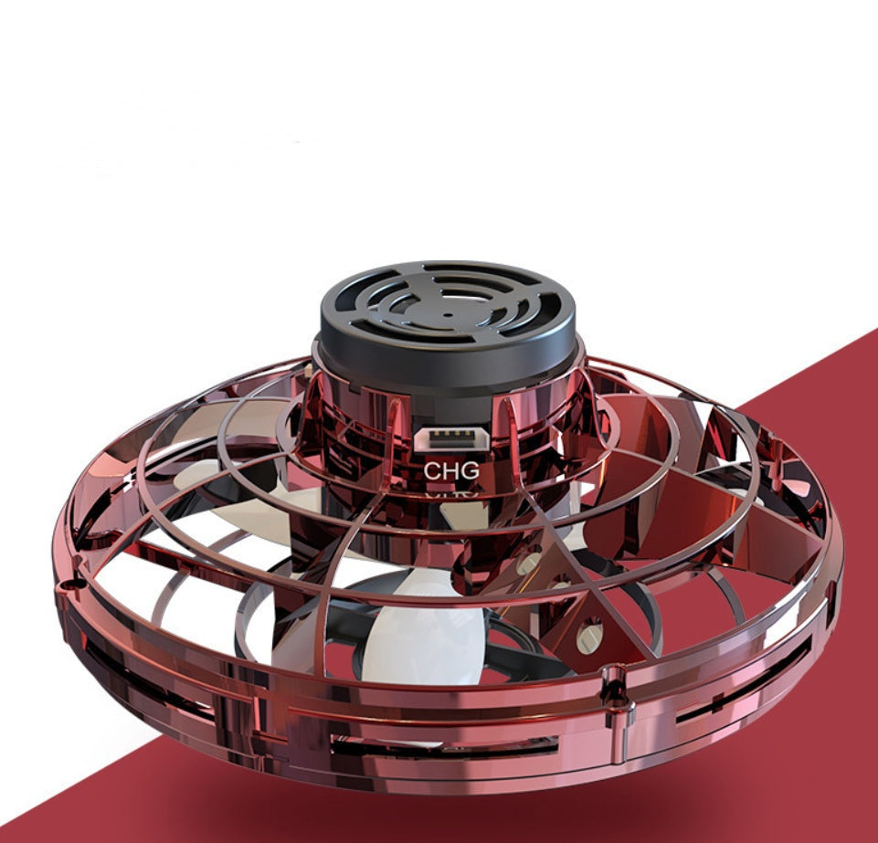 Red UFO spinning toy drone with black top and CHG label