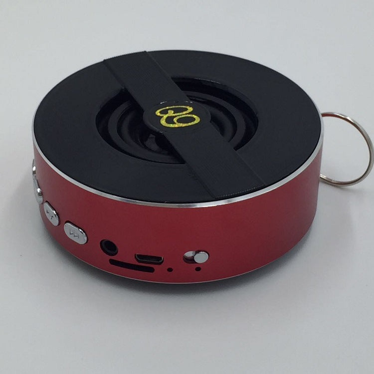 Outdoor Bluetooth speaker, red with black top, strap, and side ports