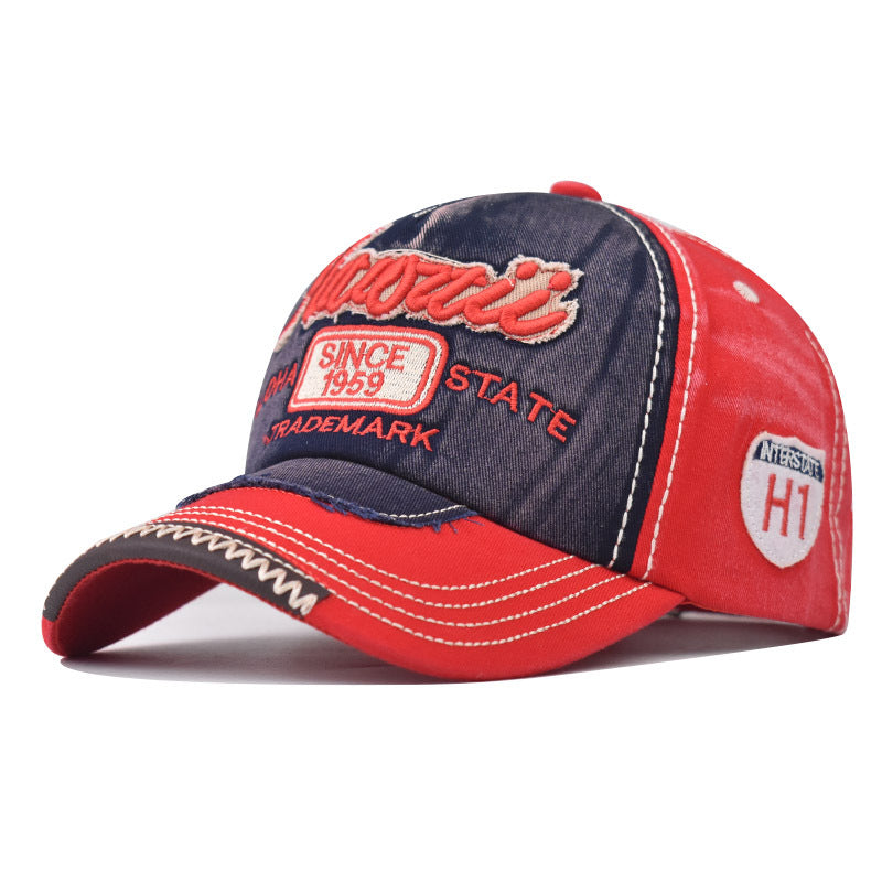 Front view two-tone cowboy style baseball cap, red crown panels with dark embroidered emblem