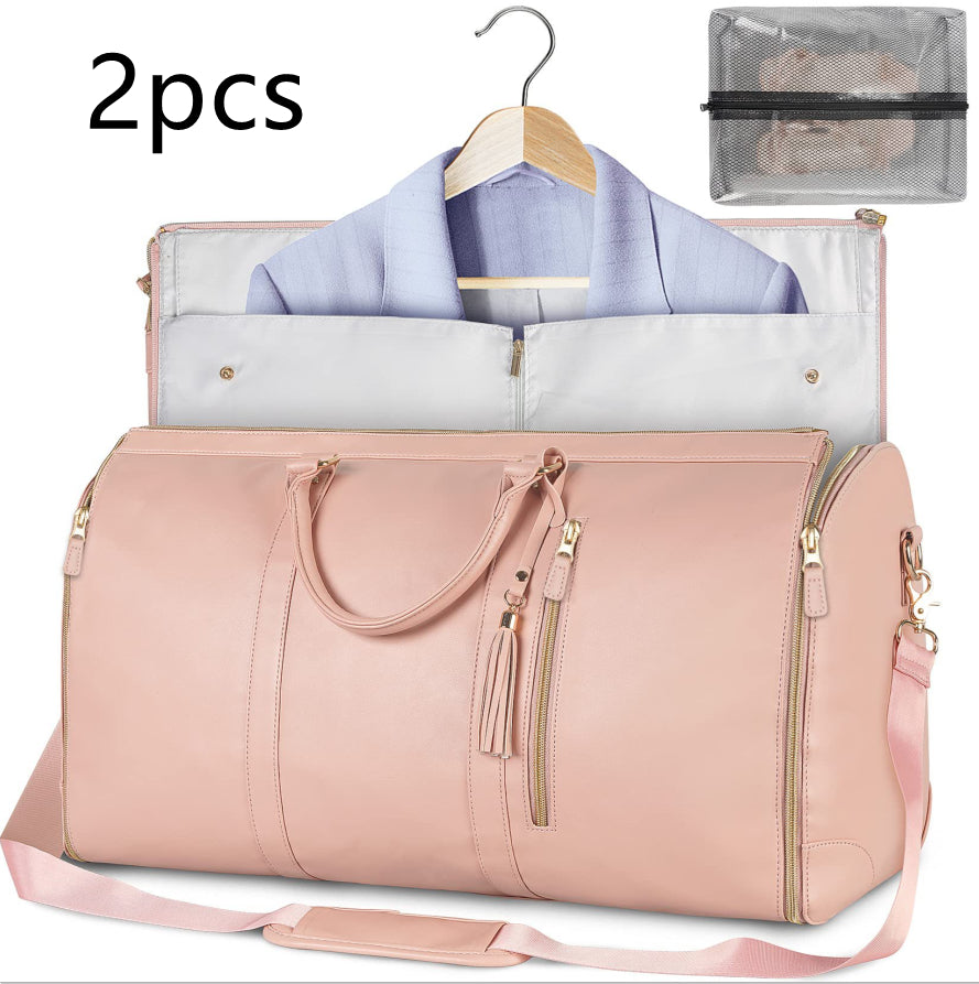 Pink travel duffle bag with hanging suit organizer, gold hardware and shoulder strap