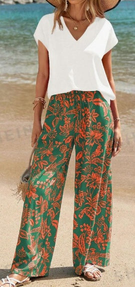 White V-neck short-sleeve top with green botanical wide-leg pants