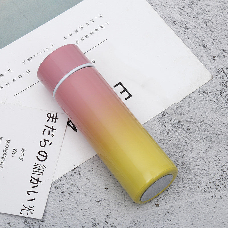 Vacuum insulated stainless steel bottle cup, pink to yellow gradient with black rim and lid
