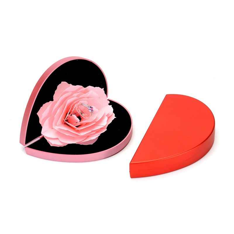 Heart-shaped ring box with pale pink rose flower and ring centerpiece