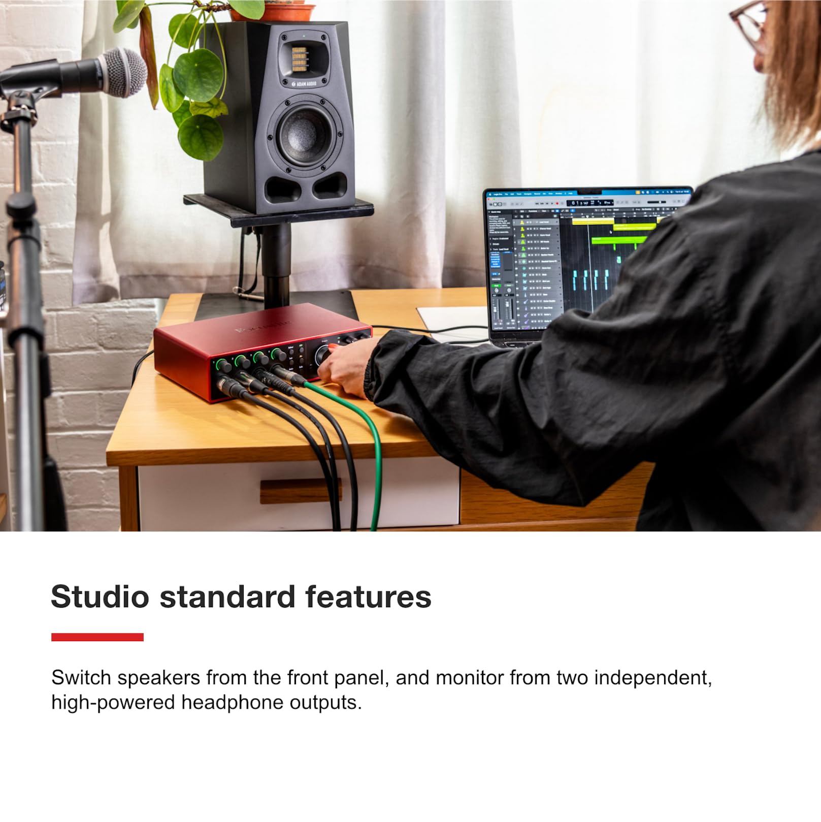 Red Focusrite Scarlett 18i16 USB audio interface on studio desk with cable connections