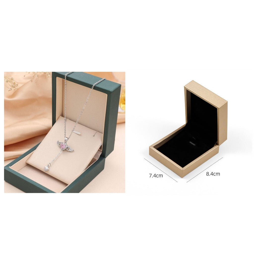 Silver angel-wing charm necklace in green gift box; beige box open view