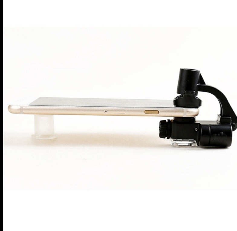 Black clip-on magnifying lens with light mounted along a smartphone edge