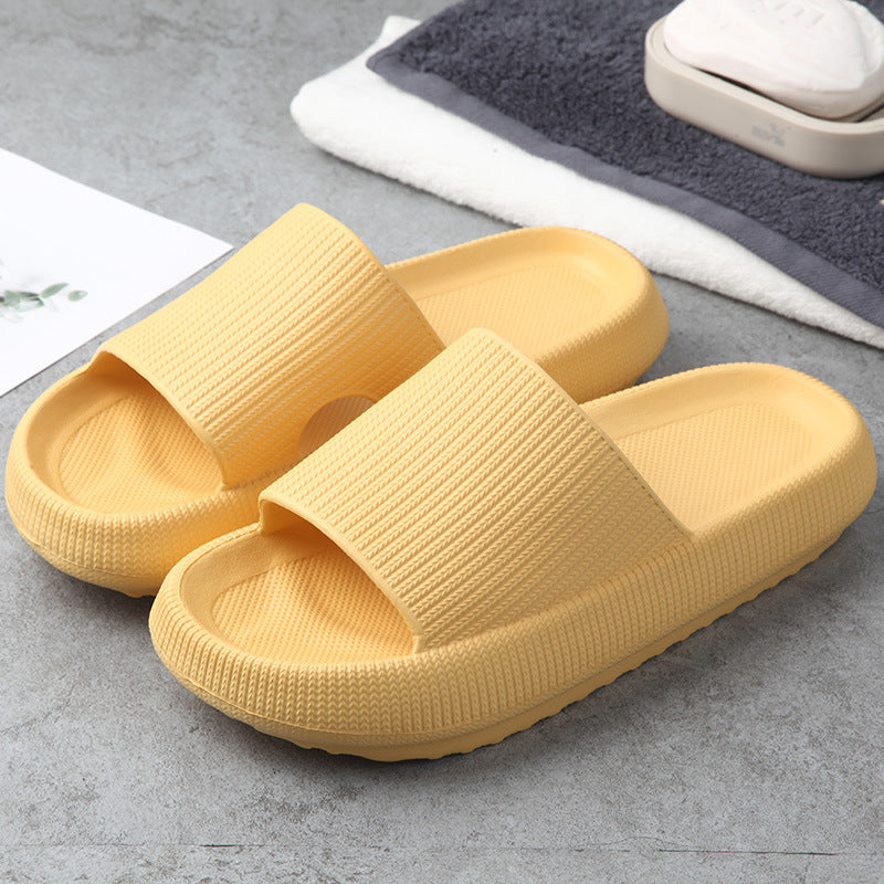Yellow knit slide slippers with open toe and cushioned footbed.