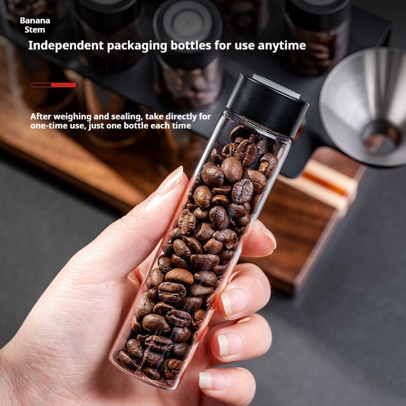 Coffee bean portioning bottle in hand, filled with roasted coffee beans.