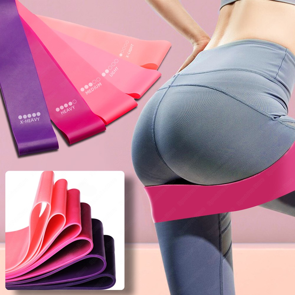 Resistance band set with purple and pink elastic bands, shown near gray leggings